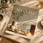 A styled flat-lay of a magazine or book titled "MARTINI vol. 10" on a sunlit beige tabletop.