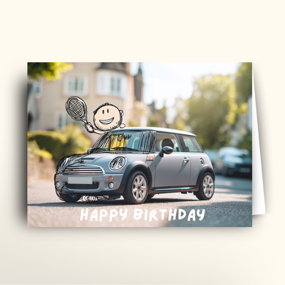 Birthday card with a Mini Cooper car and cartoon character on a blurred street background
