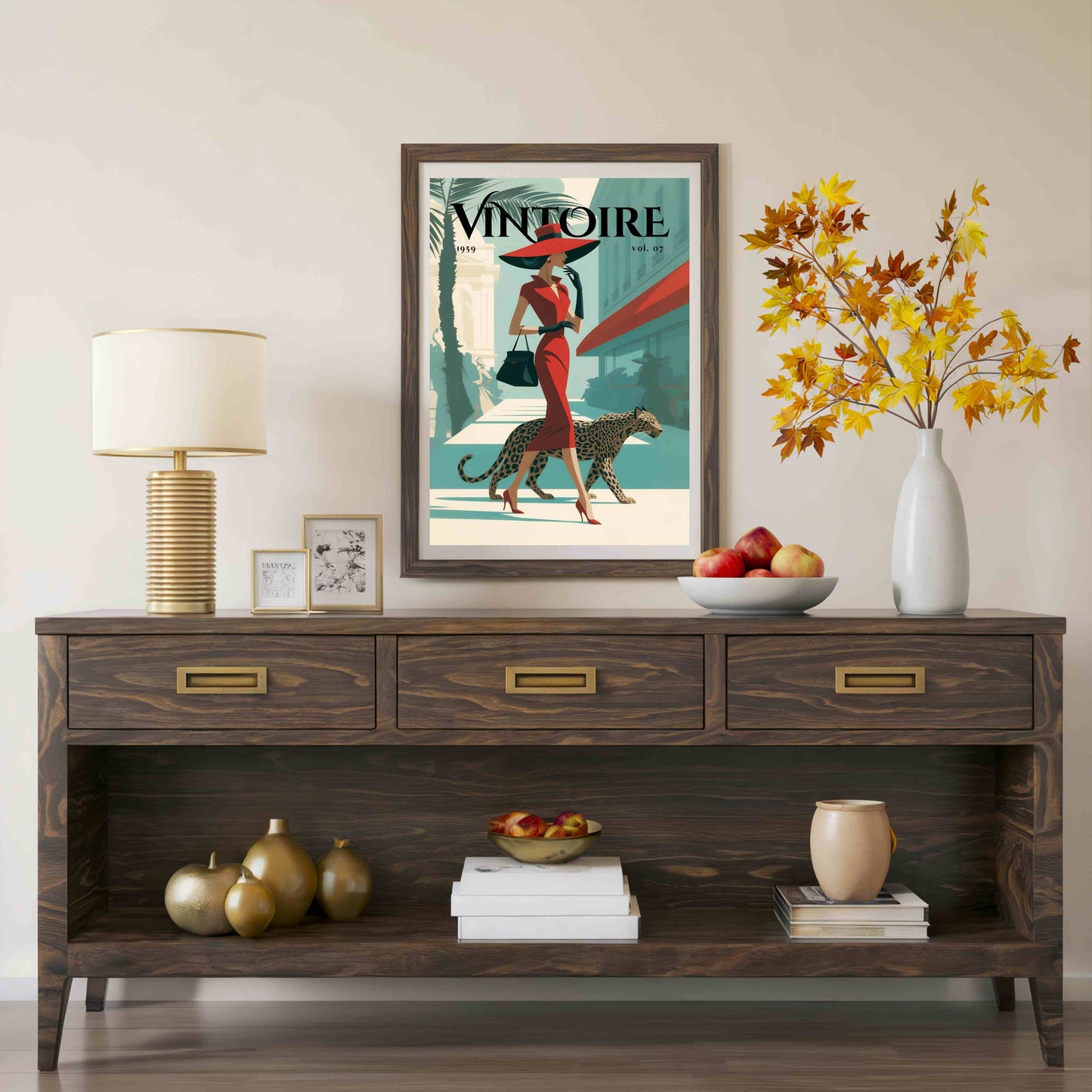 A framed vintage-style art print with the word 'VINTOIRE' hangs on a beige wall above a dark wood console table. The print shows a woman in a red dress and hat walking beside a leopard, with teal, cream, and red tones.