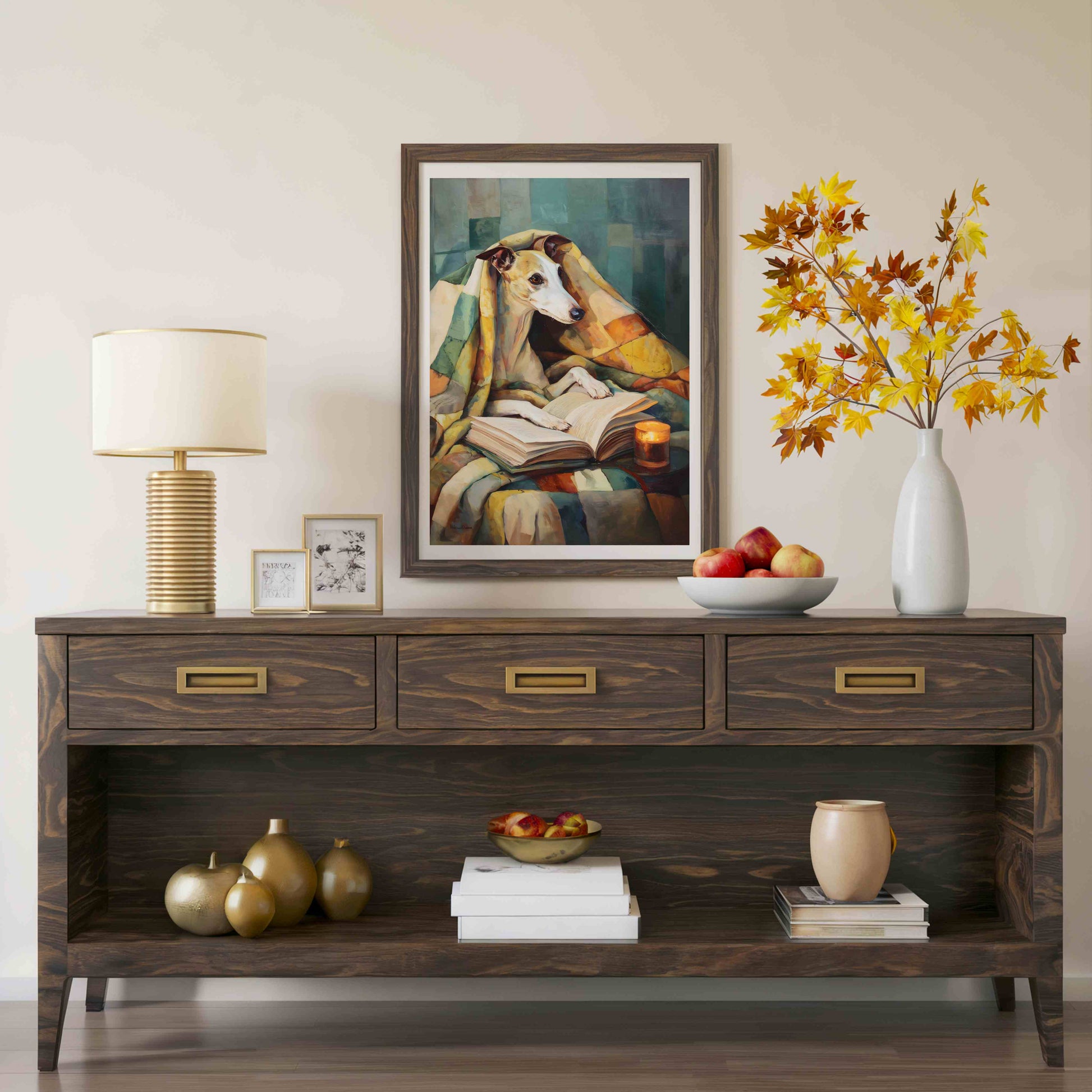 A dark wood console table styled in a living room setting, featuring a framed painting of a dog reading, a table lamp, decorative vases, and fruit bowls.