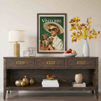 A dark wood console table styled in a living room setting, featuring a vintage 'Vintore' magazine cover print, a table lamp, a white vase with autumn leaves, and decorative accents. Retro leopard wall art poster: 1950s woman in cat-eye sunglasses holding a leopard cub, green vintage print for maximalist decor
