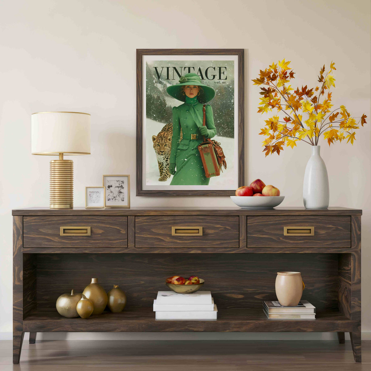 A framed vintage-style magazine cover print hangs on a beige wall above a dark wood console table. The print shows a woman in a green coat and hat holding a leopard cub, with the word 'VINTAGE' at the top.