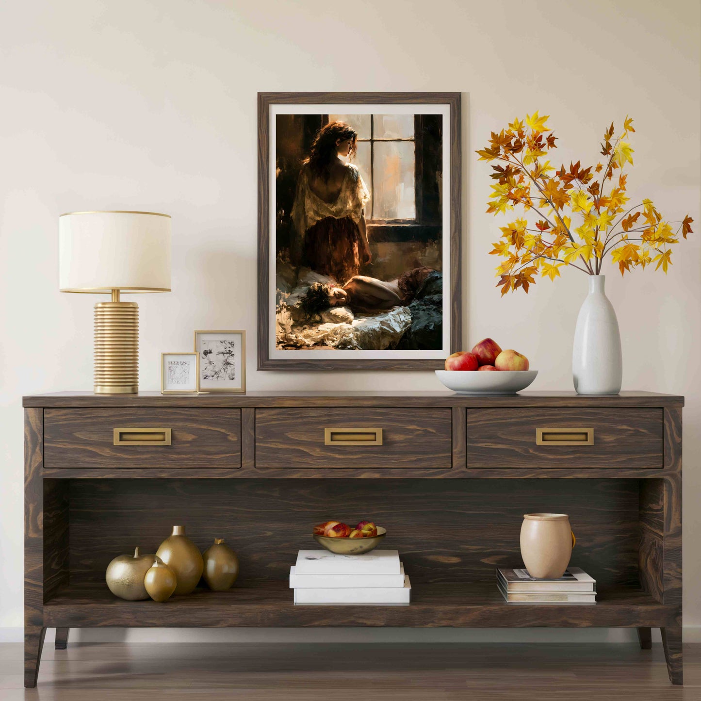 A dark wood console table styled in a living room setting, featuring a framed art print of a woman by a window, a table lamp, a white vase with autumn leaves, and decorative accents on the shelves.