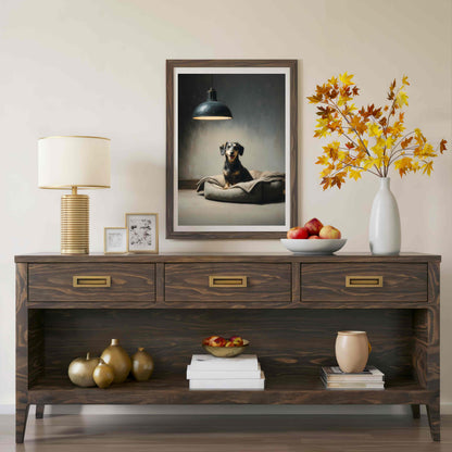 A dark wood console table styled in a living room setting, featuring a framed portrait of a dog, a table lamp, a vase with autumn leaves, and decorative objects on and below the table.