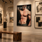 A framed vintage-style art print featuring a muscular male torso with the word 'VINTAGE' is displayed on a gallery wall, with a wooden bench in the foreground and other framed artworks in a museum setting.