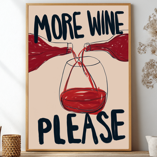 A framed wall art print with the text 'MORE WINE PLEASE' and an illustration of red wine bottles pouring into a glass, displayed on a shelf in a styled interior setting.