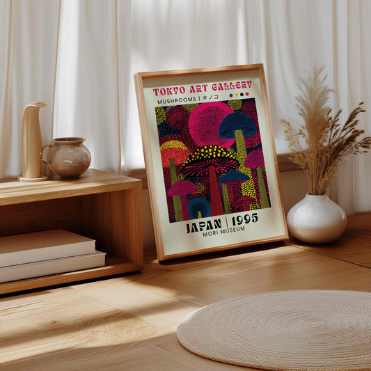 Framed artwork of neon mushrooms in dot format on a wooden surface with decorative items