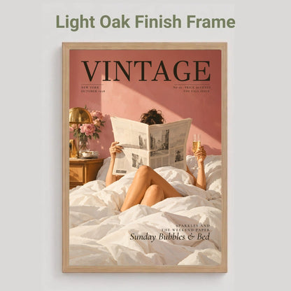 A framed art print featuring a vintage magazine cover design with a woman reading in bed, shown against a light gray background. The text above reads 'Light Oak Finish Frame'.