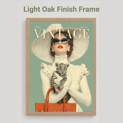 A framed art print featuring a vintage-style Vogue cover illustration of a woman in a large straw hat holding a leopard, with the text 'Light Oak Finish Frame' above it on a light gray background.