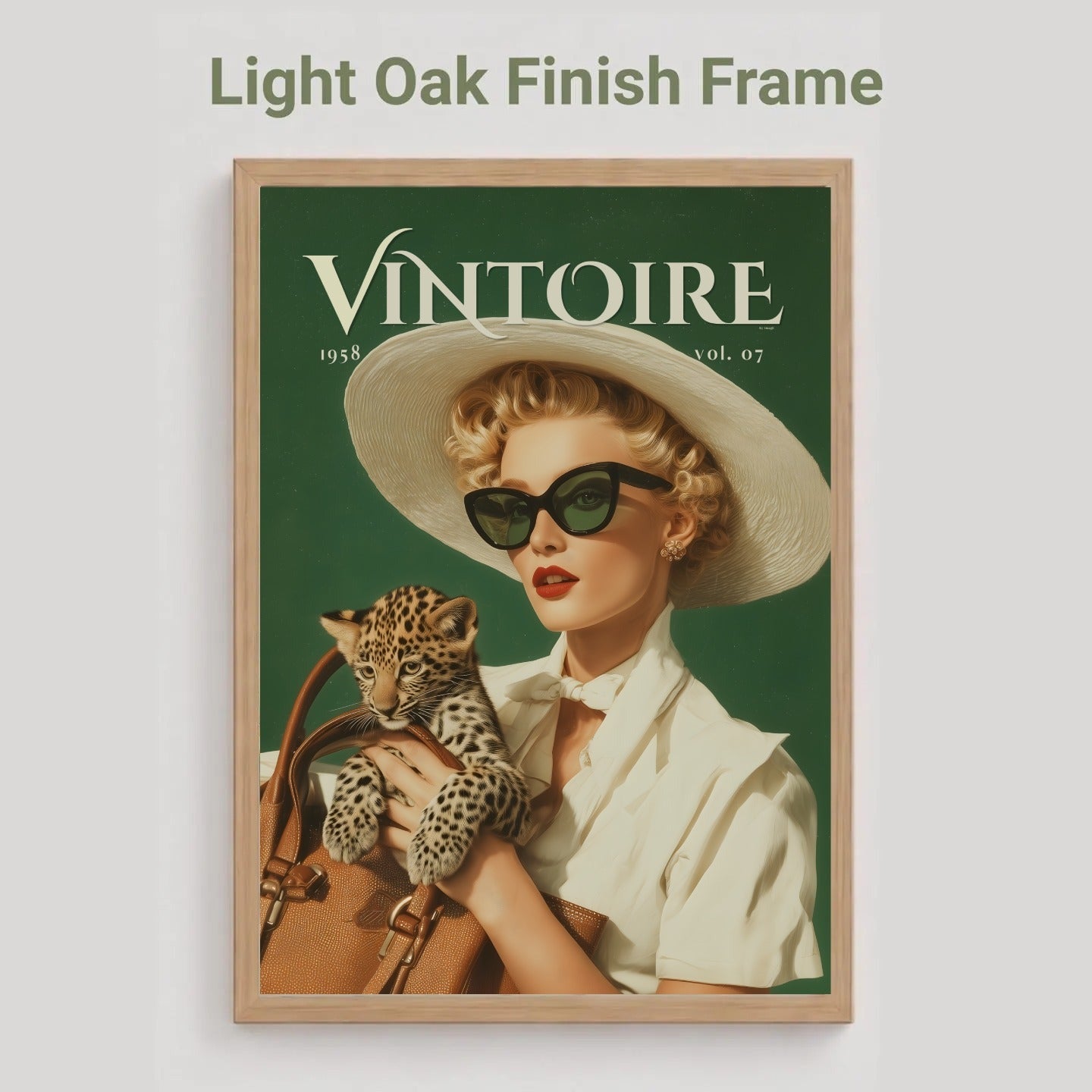 An oak framed vintage-style poster on a light gray background, with the text 'Light Oak Finish Frame' above it. The poster shows a woman in a white hat and sunglasses holding a leopard against a dark green background, with the word 'VINTOIRE' at the top. Retro leopard wall art poster: 1950s woman in cat-eye sunglasses holding a leopard cub, green vintage print for maximalist decor