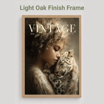 A framed art print featuring a vintage-style portrait of a woman cradling a spotted cat, with the text 'VINTAGE' across the top. The frame is light oak wood, shown against a light gray background with the text 'Light Oak Finish Frame' above it.
