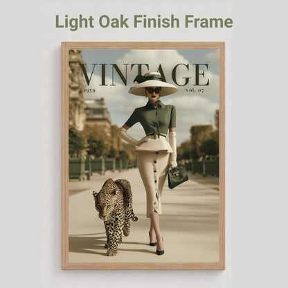 A framed vintage-style poster mockup on a light gray background, with the text 'Light Oak Finish Frame' above it. The poster shows a woman in a wide-brim hat and skirt walking a leopard along a city street, with large 'VINTAGE' lettering across the top.