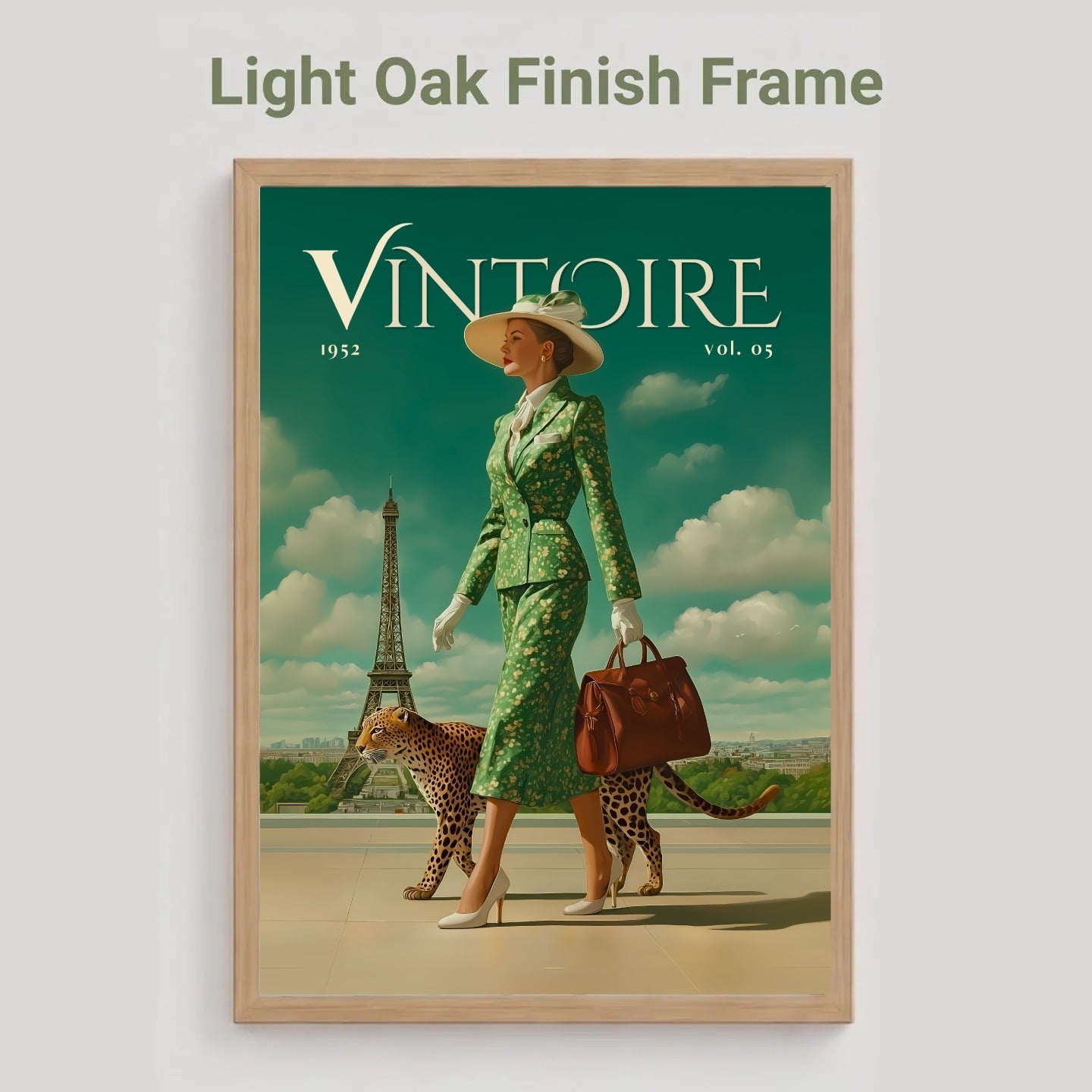 A framed art print featuring a vintage-style illustration with the title 'VINTOIRE' and the text 'Light Oak Finish Frame' above it. The artwork shows a woman in a green patterned outfit walking with two cheetahs under a teal sky, presented in a light oak frame against a light gray background.