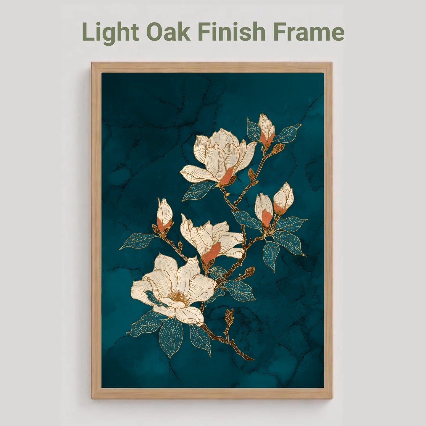 A framed floral art print featuring white magnolia blossoms on a dark teal marbled background, shown in a light oak finish frame against a light gray wall. Text above reads 'Light Oak Finish Frame'.