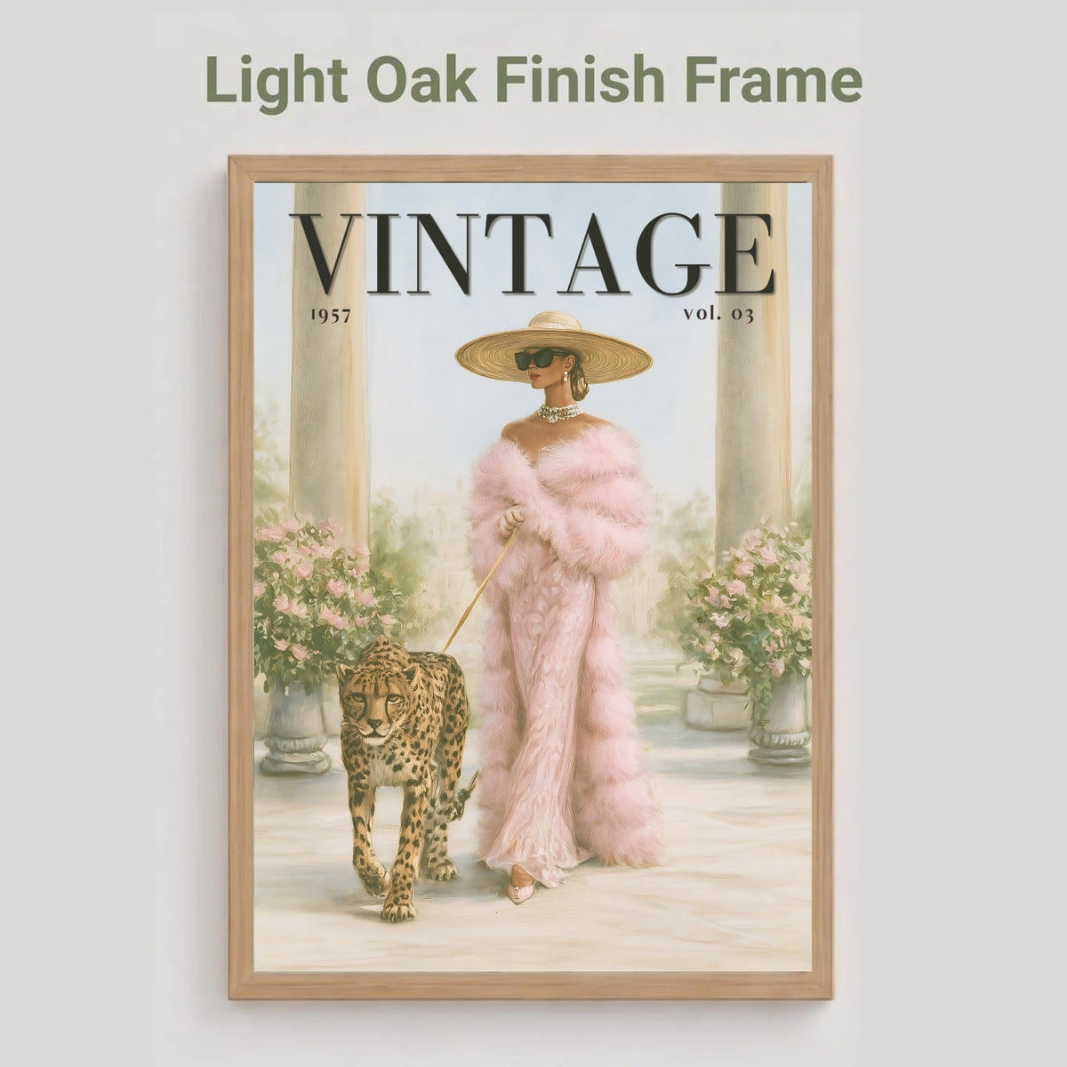 A framed art print featuring a vintage magazine cover illustration with the word VINTAGE at the top, shown against a light gray background. The print depicts a woman in a pink fur coat and hat walking a leopard, enclosed in a light oak finish frame.