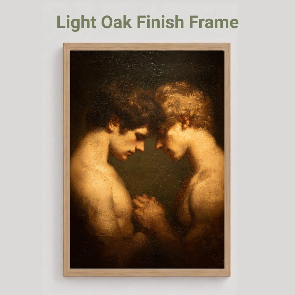 A framed art print featuring a classical painting of two nude male figures facing each other, displayed on a light gray background with the text 'Light Oak Finish Frame' above it.
