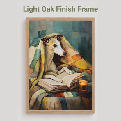 A framed art print featuring a painted whippet dog wrapped in a plaid blanket and reading an open book, with a small candle beside it. The text 'Light Oak Finish Frame' appears above the frame on a light gray background.