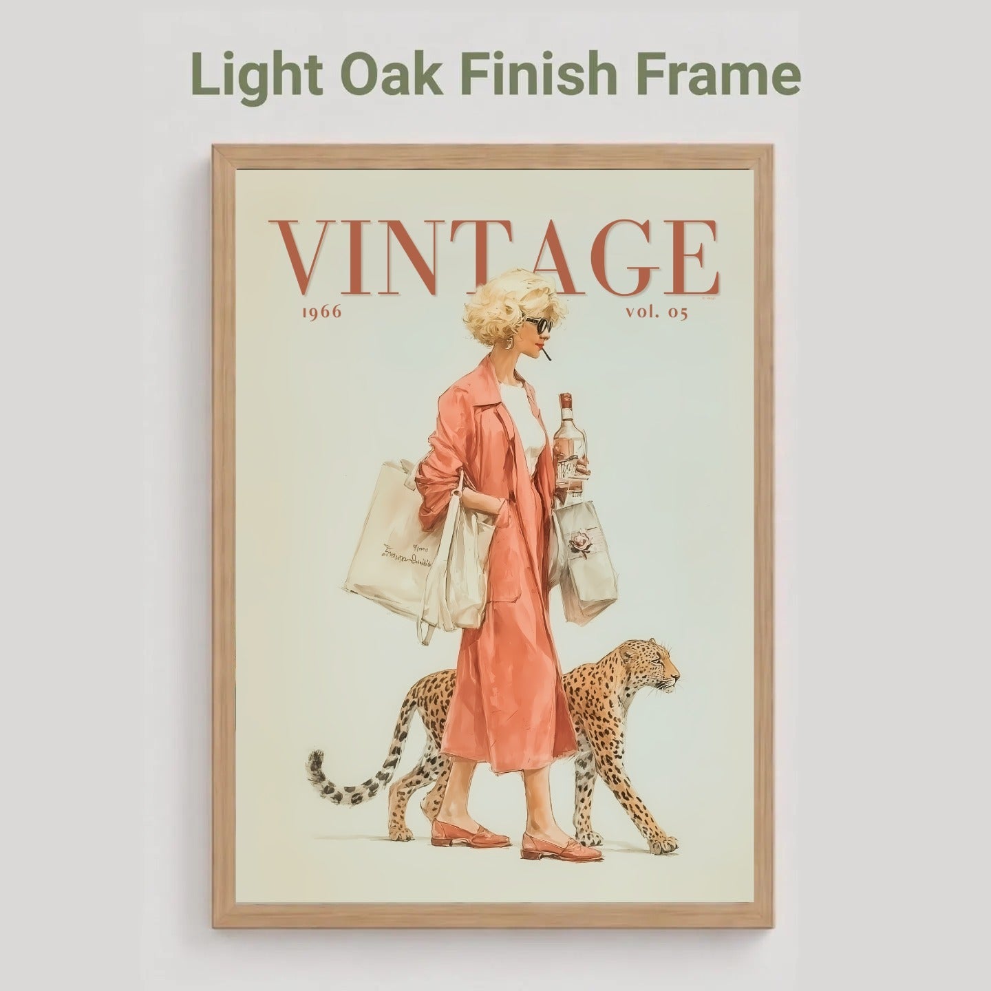 A framed vintage-style poster on a light gray background, with the text 'Light Oak Finish Frame' above it. The poster shows a woman in a pink coat walking with a cheetah, with the word 'VINTAGE' at the top and '1946 vol.