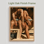A framed art print featuring a warm-toned painting of seated figures, displayed against a light gray background with the text 'Light Oak Finish Frame' above it.
