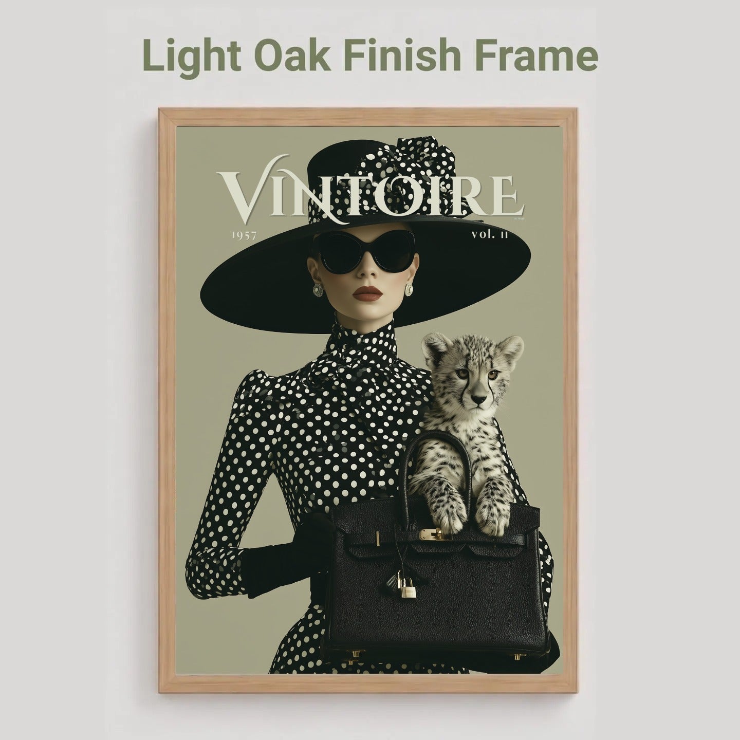 A framed art print featuring a vintage fashion illustration with the title 'VINTOIRE' and a cat, shown against a light gray background with the text 'Light Oak Finish Frame' above it.