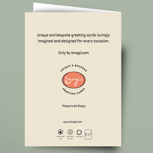 A single greeting card shown flat against a muted sage green background. The card is cream-colored with black printed text and a central coral-pink oval logo reading 'imagii greeting cards.