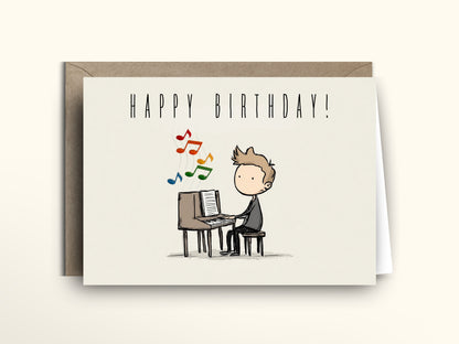 Birthday card with a cartoon illustration of a person playing music on a keyboard, with 'Happy Birthday!' text above.
