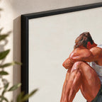 Close-up of the Rest gay art print in a black frame, showing warm blocky brushstrokes on the folded arms and knees against the off-white background