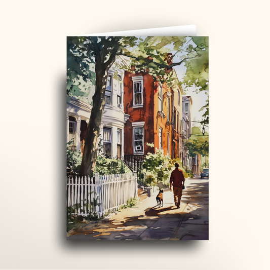 Greeting card of a person walking a dog on a street with houses and trees.