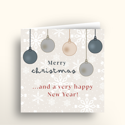 Christmas card with hanging ornaments and festive text on a white background