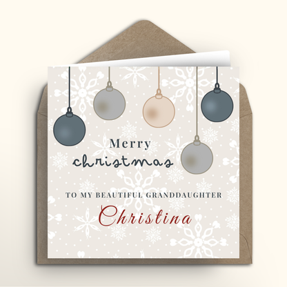 Christmas card with hanging ornaments and personalized text on a white background