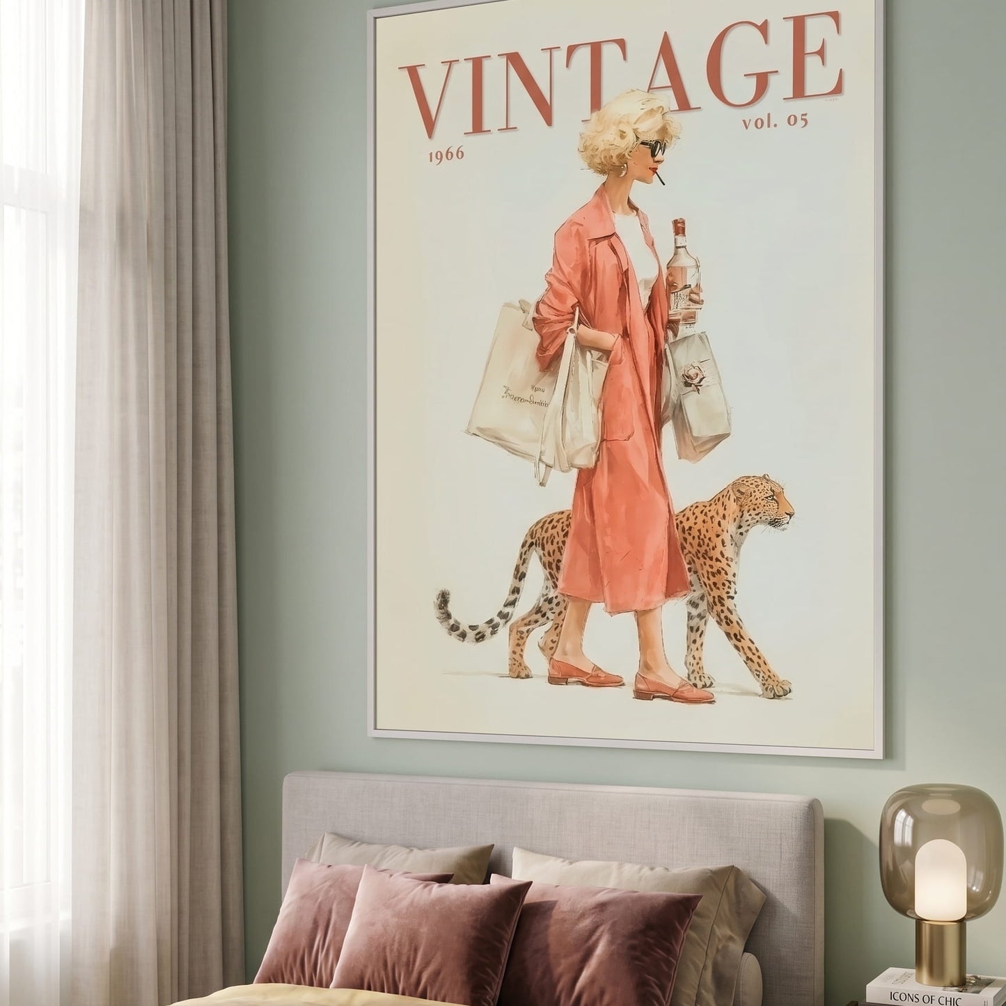 A framed vintage-style wall art print hangs above a bed in a styled bedroom. The print features the word VINTAGE at the top and an illustration of a woman in a peach dress walking with a leopard, holding shopping bags.