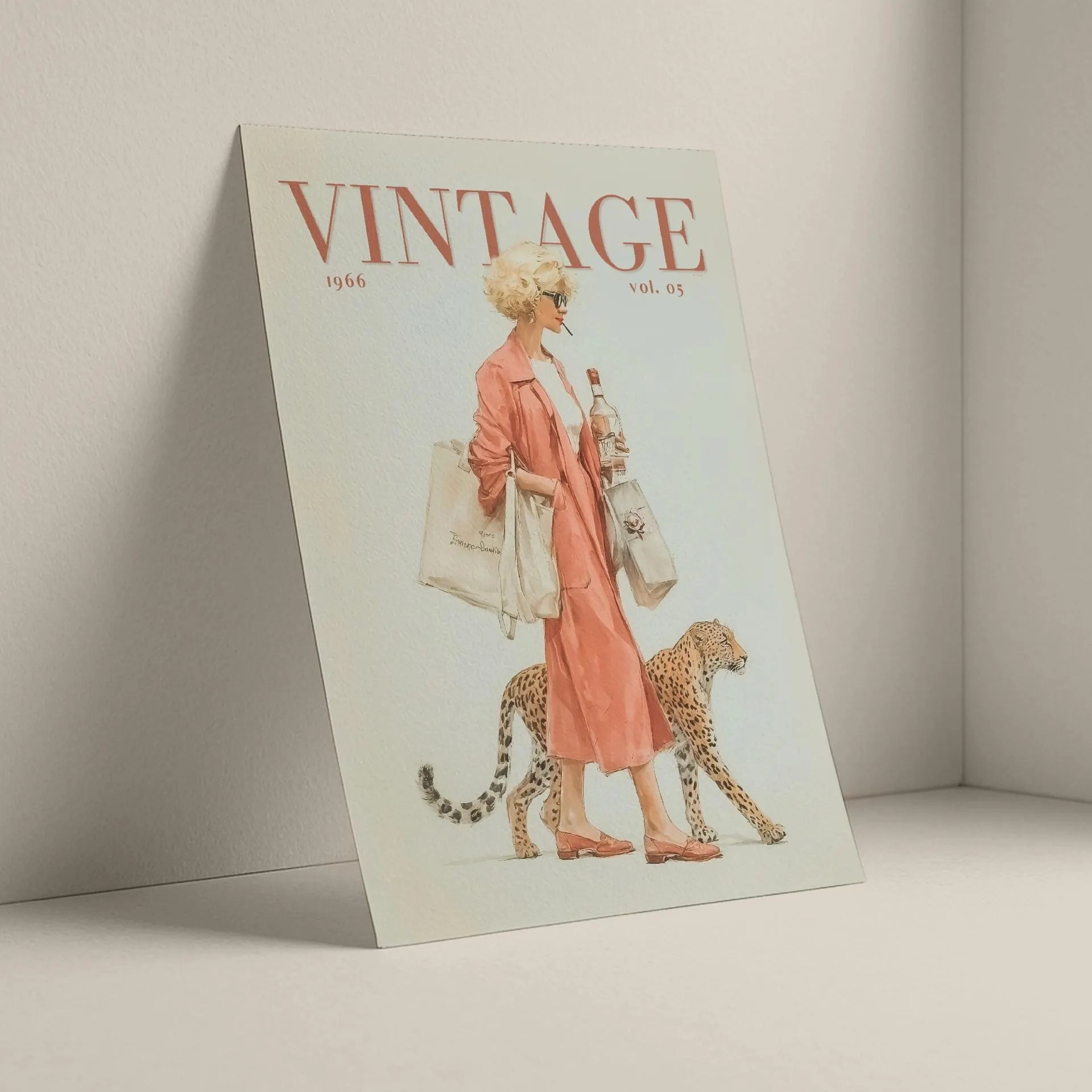 A vintage illustrated magazine titled VINTAGE, shown standing against a light neutral wall. The cover features a woman in a pink dress walking beside a cheetah, with the title 'VINTAGE' in large red letters at the top.