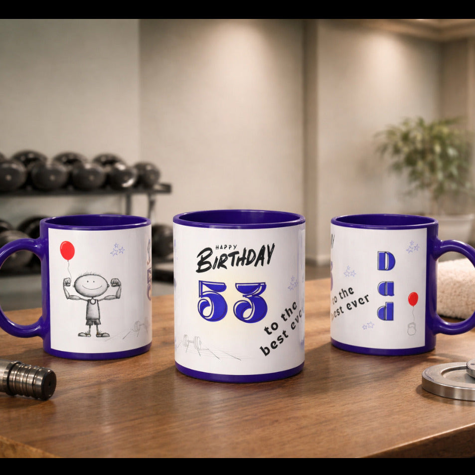 Three mugs with birthday designs on a wooden surface in a gym setting
