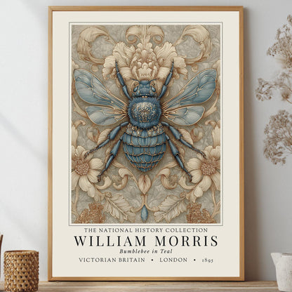 A framed William Morris art print featuring a detailed blue and beige bumblebee illustration, styled on a shelf with dried botanicals and small decorative vases against a light gray wall.