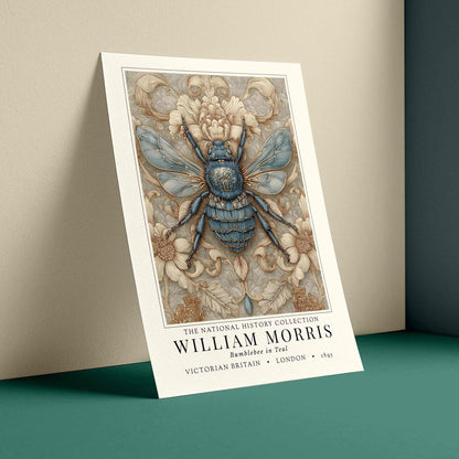 A vertical art print poster of William Morris's 'Backdrop in Elf' featuring a detailed blue and beige Victorian-era bumblebee illustration, shown leaning against a wall on a teal surface.