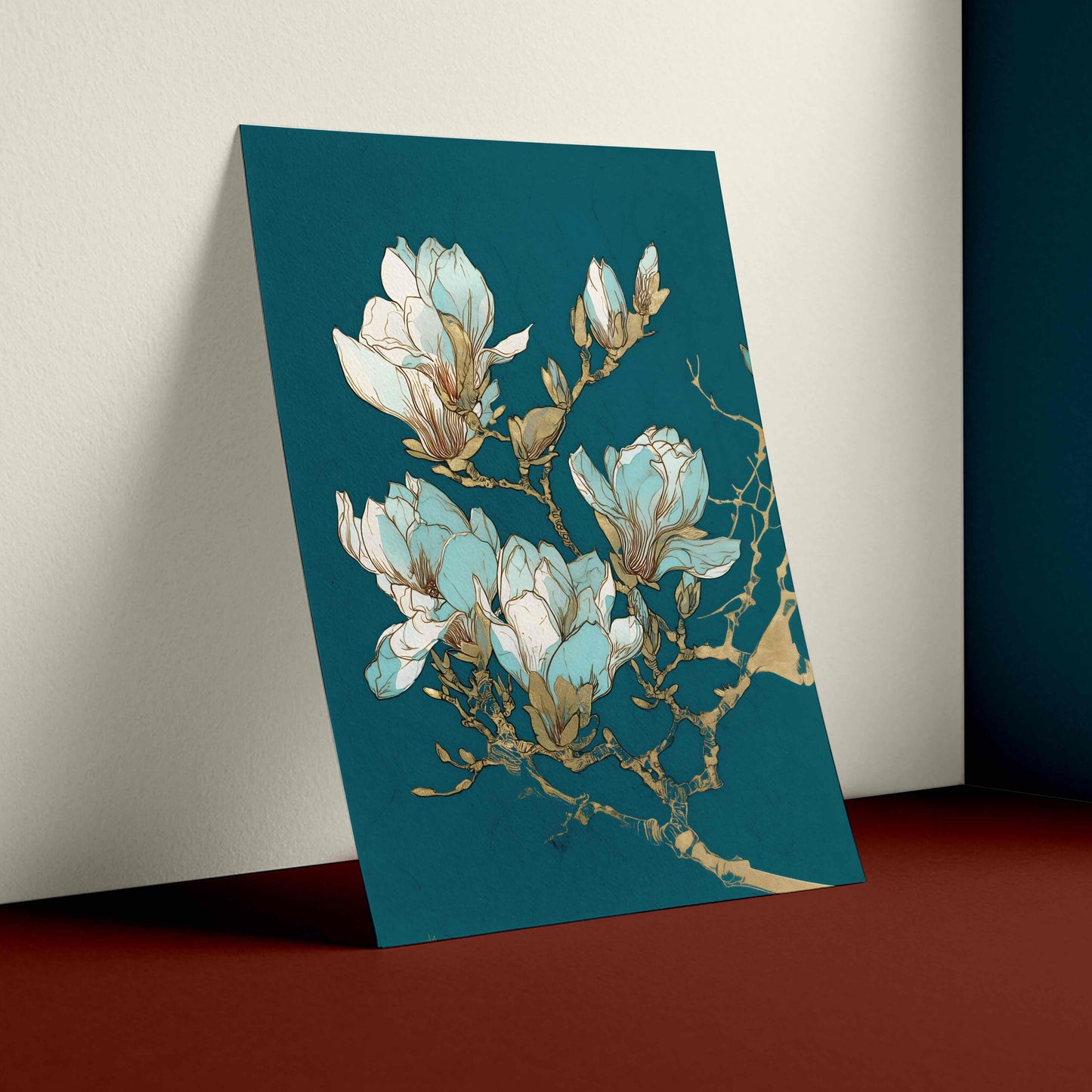 A vertical art print featuring a botanical illustration of white and light blue magnolia blossoms with gold branch details, displayed leaning against a wall in a styled interior setting.