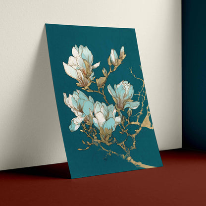 A vertical art print featuring a botanical illustration of white and light blue magnolia blossoms with gold branch details, displayed leaning against a wall in a styled interior setting.