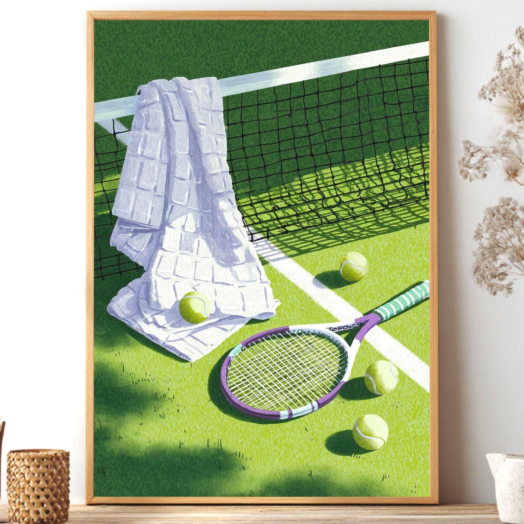 Framed artwork of a tennis scene with a racket, balls, and towel on grass. Vintage tennis racket, towel and balls resting on a grass court, retro lilac and sage tennis wall art print
