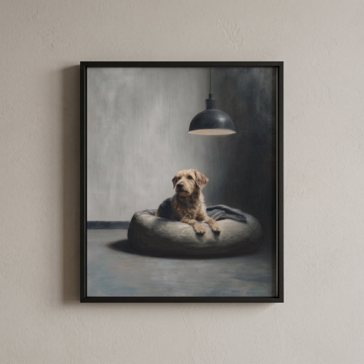 A framed wall art print hanging on a light beige textured wall. The artwork depicts a small tan dog lying on a round gray cushion under a hanging lamp in a moody gray room.