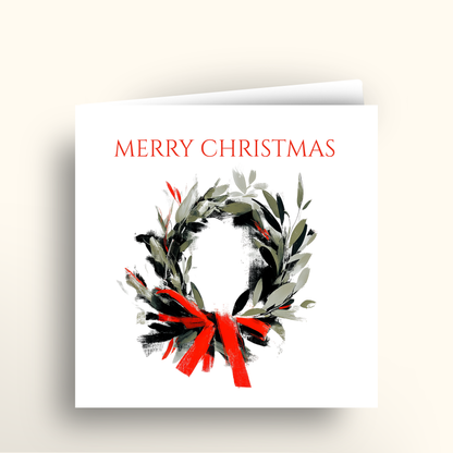 Christmas card with a wreath and red ribbon on a white background