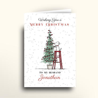 Christmas card with a dog on a ladder and Christmas tree, personalized for 'Jonathan'.