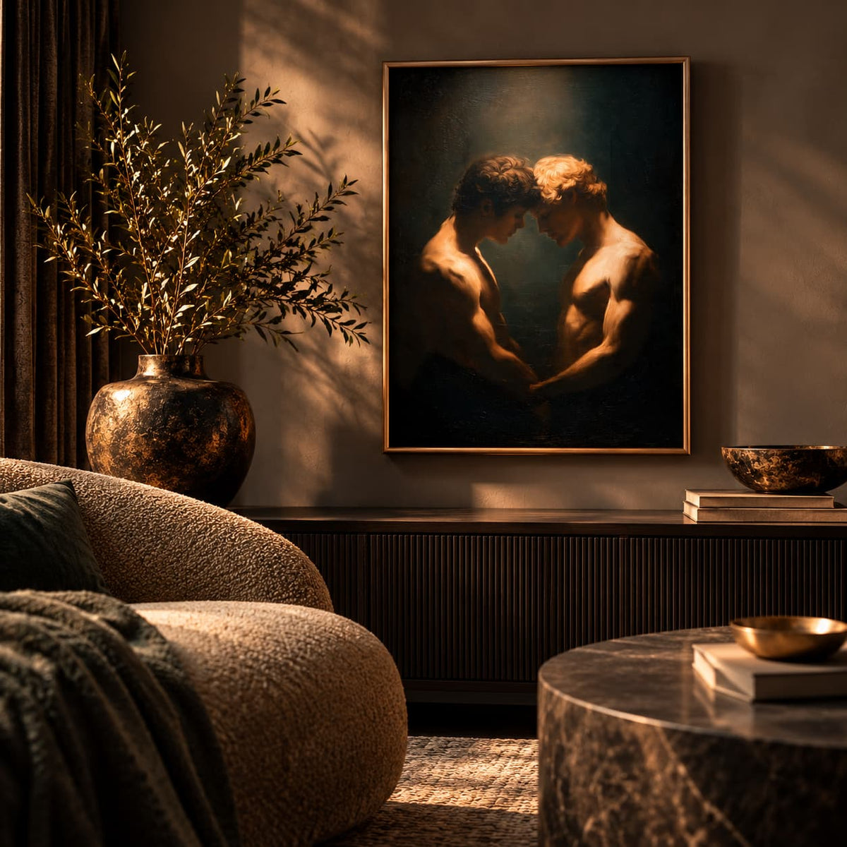 A framed classical-style painting of two nude male figures in a dark, dramatic scene, displayed on a wall in a luxurious, warmly lit living room with a textured armchair, marble table, and a large vase of branches.