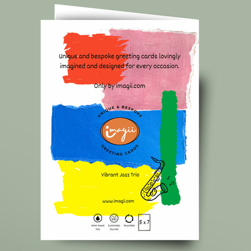A greeting card shown against a muted green background. The card features a colorful abstract watercolor design with red, pink, blue, yellow, and green brushstrokes, along with a saxophone illustration and the Imagii brand logo.
