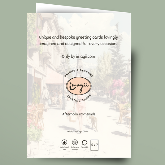 A folded greeting card shown against a muted sage green background. The card front features a faded street scene with text reading 'Unique and bespoke greeting cards lovingly imagined and designed for every occasion.