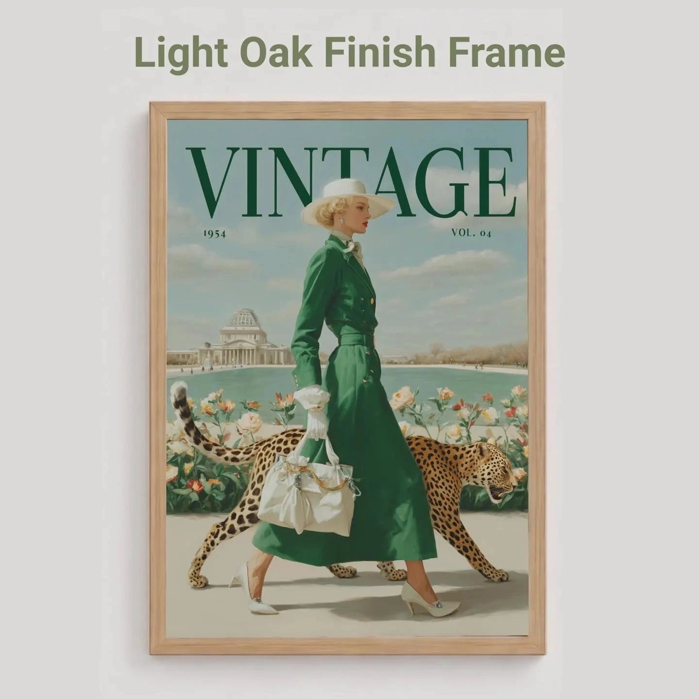 A framed vintage-style poster or magazine cover featuring a woman in a green dress walking with a leopard, with the word VINTAGE at the top. The frame is light oak wood, and the image is shown against a light gray background with the text 'Light Oak Finish Frame' above.