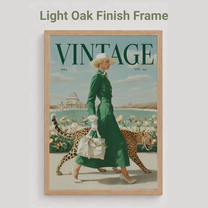 A framed vintage-style poster or magazine cover featuring a woman in a green dress walking with a leopard, with the word VINTAGE at the top. The frame is light oak wood, and the image is shown against a light gray background with the text 'Light Oak Finish Frame' above.