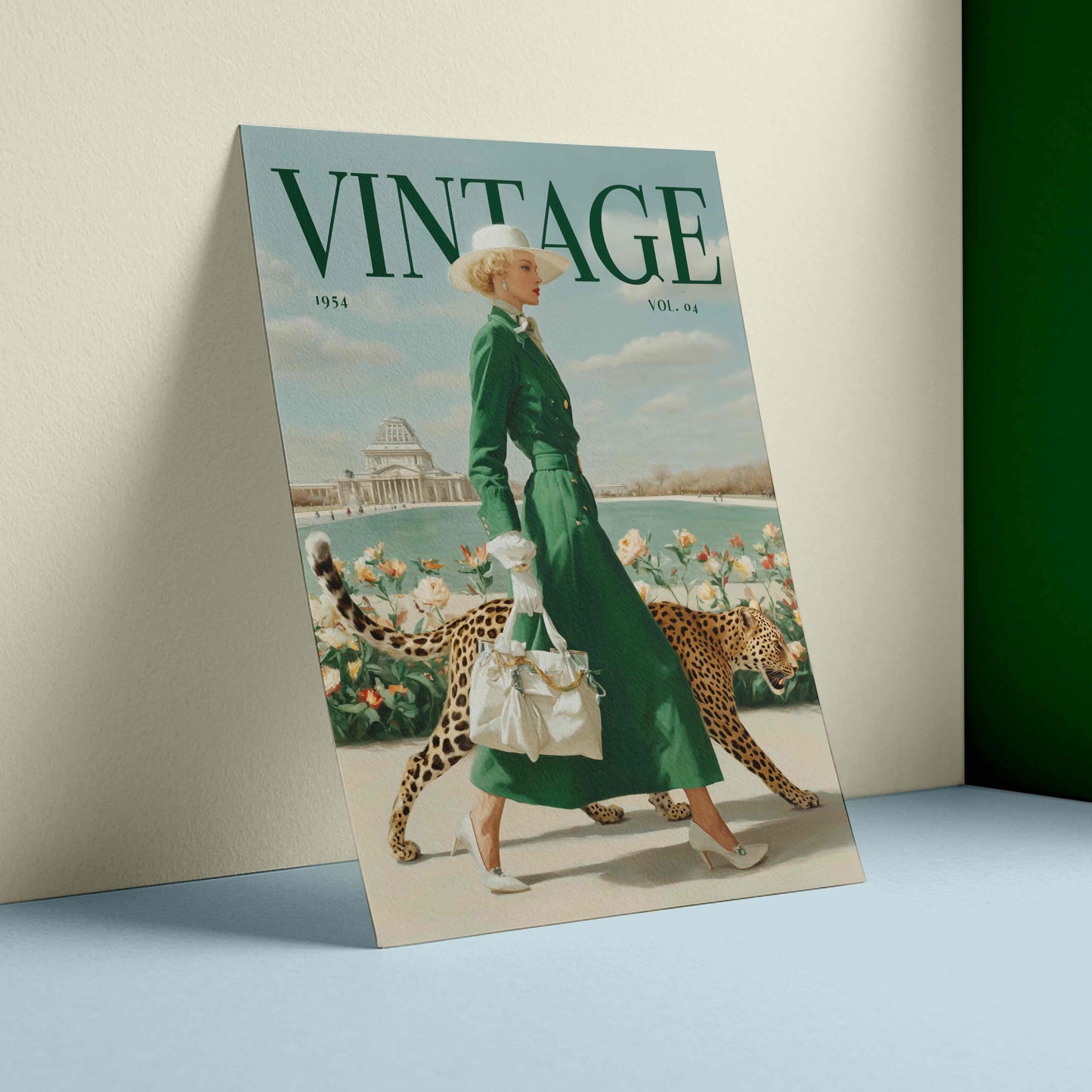 A vintage-style illustrated poster or print leaning against a wall on a light blue surface. The artwork shows a woman in a long green dress walking with two cheetahs near water and flowers, with the large word 'VINTAGE' across the top.