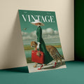 A vintage-style illustrated magazine or poster cover titled VINTAGE, leaning against a beige wall on a teal surface. The cover art shows a woman in a long green dress and white hat carrying a red suitcase, accompanied by a leopard, with a landscape and birds in the background.