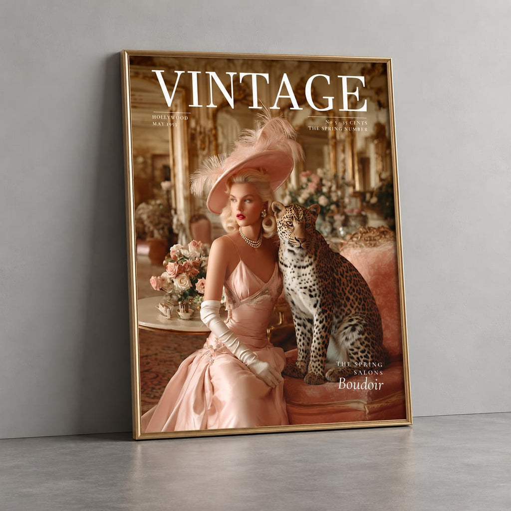 A framed art print leaning against a gray wall on a concrete floor. The print features a vintage photograph of a woman in a pink satin gown and feathered hat sitting next to a leopard, with the word 'VINTAGE' printed at the top.