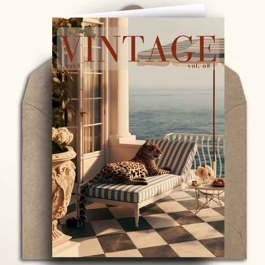A vintage-style greeting card featuring a luxurious balcony scene with a leopard lounging on a striped chaise lounge by the sea, shown with a kraft envelope behind it. The card prominently displays the word 'VINTAGE' at the top.